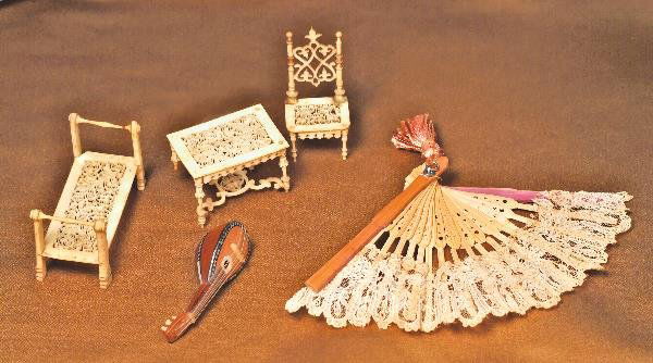 MINIATURE ACCESSORY GROUP. Includes: three pie: MINIATURE ACCESSORY GROUP. Includes: three pieces nineteenth-century miniature ivory furniture consisting of 2 ¼" H. chair, table and bench, each piece of superbly carved and filigreed ivory; 2 ¼" w
