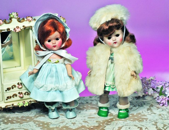 VOGUE GINNY 1953 TINY MISS SERIES. Marks: Vogue: VOGUE GINNY 1953 TINY MISS SERIES. Marks: Vogue Doll. 8". All-hard plastic, strung doll, brown sleep eyes, painted lashes, auburn wig, white fur coat and hat over tagged green and white cotton dress w
