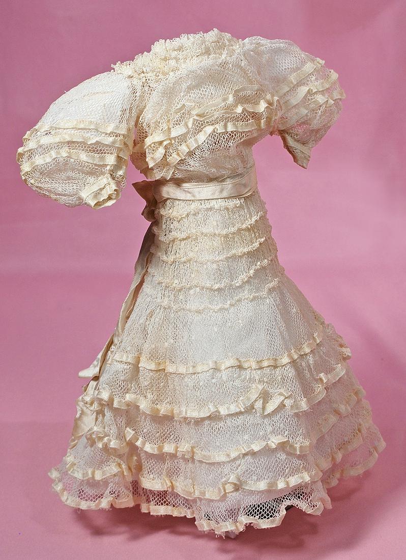 FINE ANTIQUE WHITE DOTTED SWISS LADY DRESS.: FINE ANTIQUE WHITE DOTTED SWISS LADY DRESS. 3" shoulders, 12" length, 6" waist. Dainty dotted swiss made up in gown with gathered bodice and puffed sleeves, ruching detail at neckline, decorated with 
