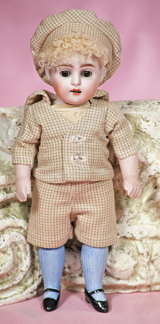 GERMAN ALL-BISQUE DOLL BY KESTNER.: GERMAN ALL-BISQUE DOLL BY KESTNER. 8". Marks: 150. All-bisque, jointed at shoulders and hips, brown sleep eyes, painted lower lashes, feathered brows, open mouth, shaded lips, upper teeth, blonde lamb