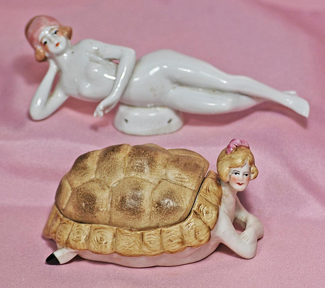 BISQUE BATHING BEAUTY WITH TURTLE SHELL & PORCELAIN: BISQUE BATHING BEAUTY WITH TURTLE SHELL & PORCELAIN NUDE BATHING BEAUTY. The bisque head of a bathing beauty with sculpted hair accented with pink bow is protruding from a bisque turtle shell, her fee