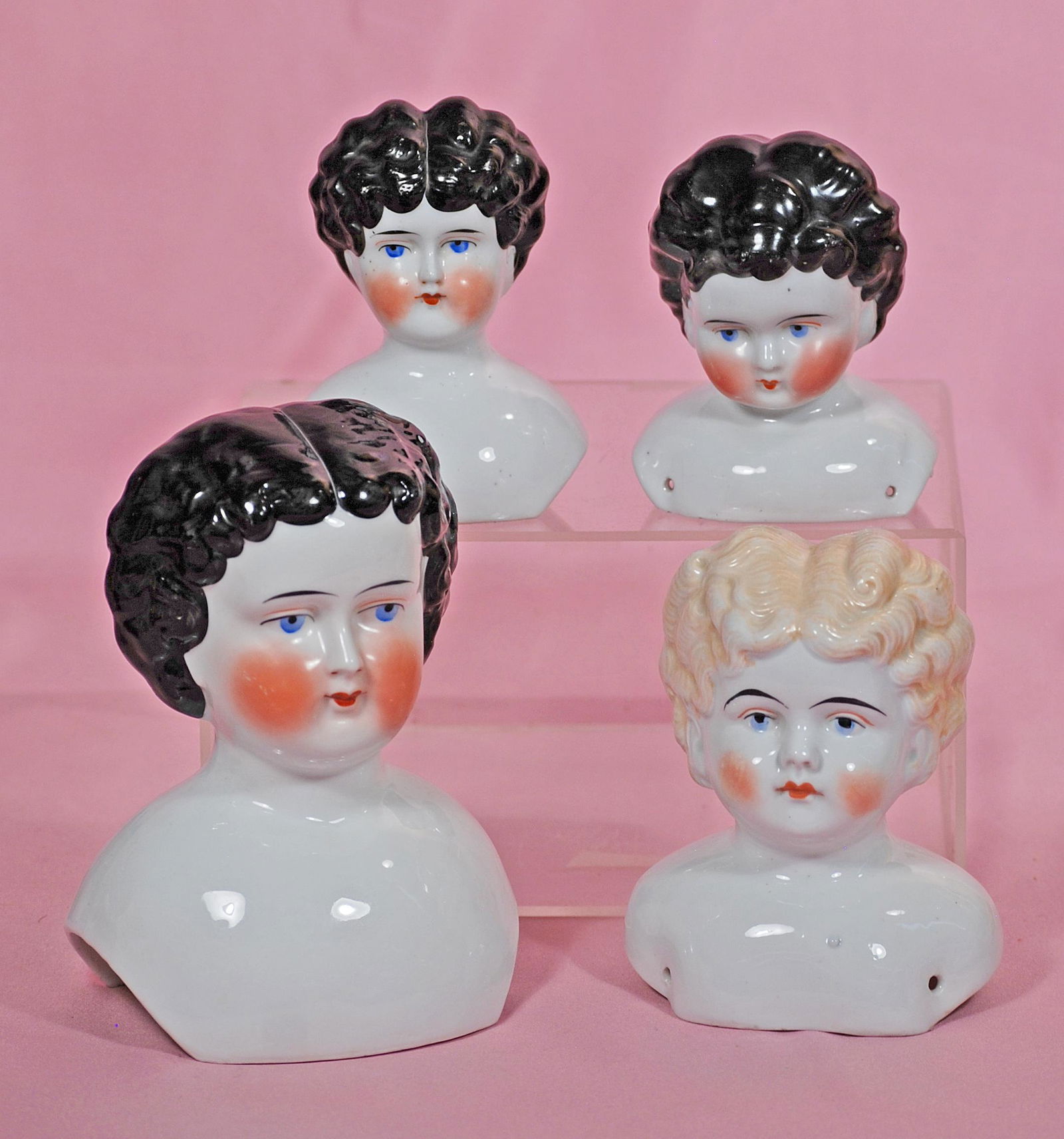 FOUR GERMAN PORCELAIN DOLL HEADS. Largest is 6 ½”. (1 of 1)