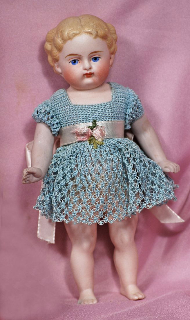 ALL-BISQUE DOLL WITH SCULPTED HAIR AND BARE FEET: 275. GERMAN ALL-BISQUE DOLL WITH SCULPTED HAIR AND BARE FEET. 6 ½”. All-bisque, jointed at shoulders, shaped legs with bare feet, sculpted blonde hair, painted features, blue eyes, red and black li