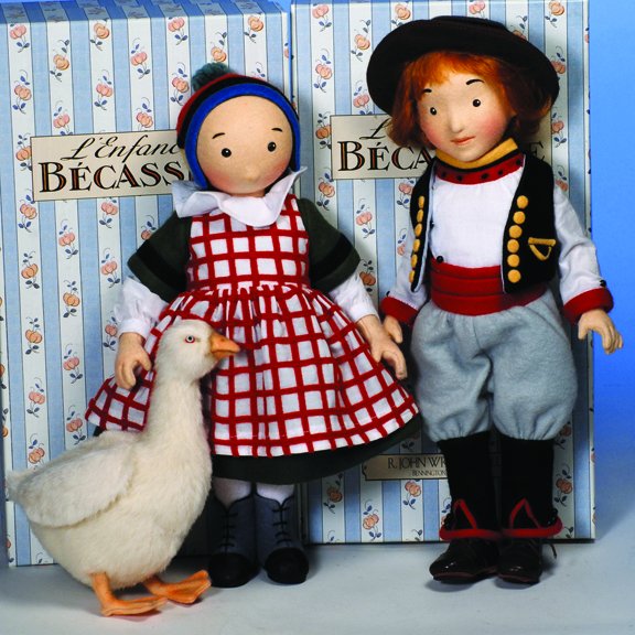 R. JOHN WRIGHT "BECASSINE & JOEL". 12" & 13".: R. JOHN WRIGHT "BECASSINE & JOEL". 12" & 13". La Enfance de Becassine & companion Joel" all felt; fully jointed; molded felt face with hand painted features; mohair wig. Dressed in felt and cotton pro