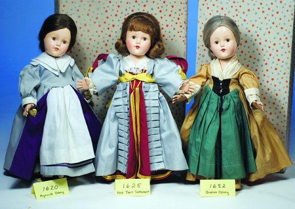 EFFANBEE 1625 NEW YORK SETTLEMENT. Blue eyes, sty: EFFANBEE 1625 NEW YORK SETTLEMENT. Blue eyes, styled brown wig with bangs, costume of gray and maroon cotton with gold braid trim and ribbons, stand-up lace collar, petticoat, pantaloons, black leathe