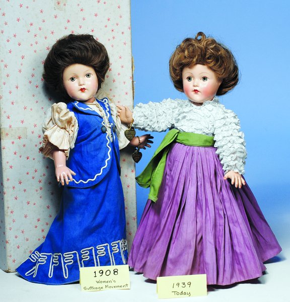 EFFANBEE 1908 WOMEN'S SUFFRAGE MOVEMENT. Blue ey: EFFANBEE 1908 WOMEN'S SUFFRAGE MOVEMENT. Blue eyes, brown hair waved back from face into bun, blue and white cotton dress with slender skirt and demi-train, gathered full sleeves, tiny buttons down fr