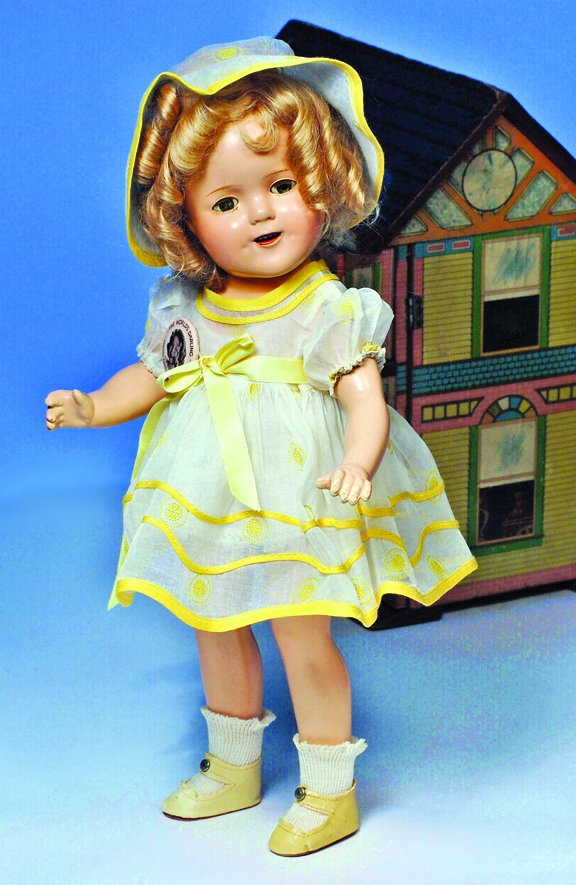SHIRLEY TEMPLE IN YELLOW "STAND UP & CHEER" COSTU: SHIRLEY TEMPLE IN YELLOW "STAND UP & CHEER" COSTUME. Marks: None. 15". White and yellow dotted cotton dress with yellow trim, rayon Shirley Temple tag, matching hat, ivory leatherette shoes, original 