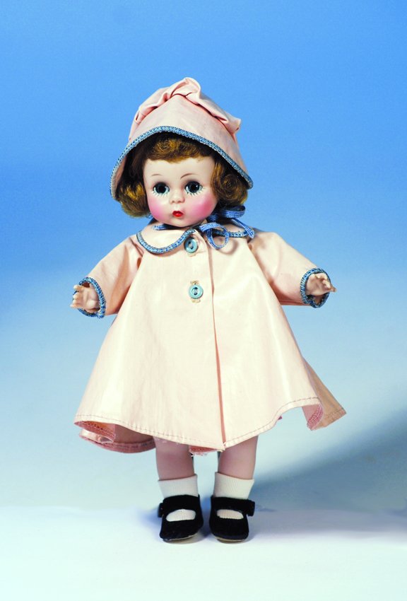 ALEXANDER-KIN "WENDY LIKES A RAINY DAY" BY MME. AL: ALEXANDER-KIN "WENDY LIKES A RAINY DAY" BY MME. ALEXANDER. Marks: Alex. 8". Hard plastic, bend-knee walker, tosca wig, blue sleep eyes, wears tagged pink vinyl raincoat and hat with blue edging and bu