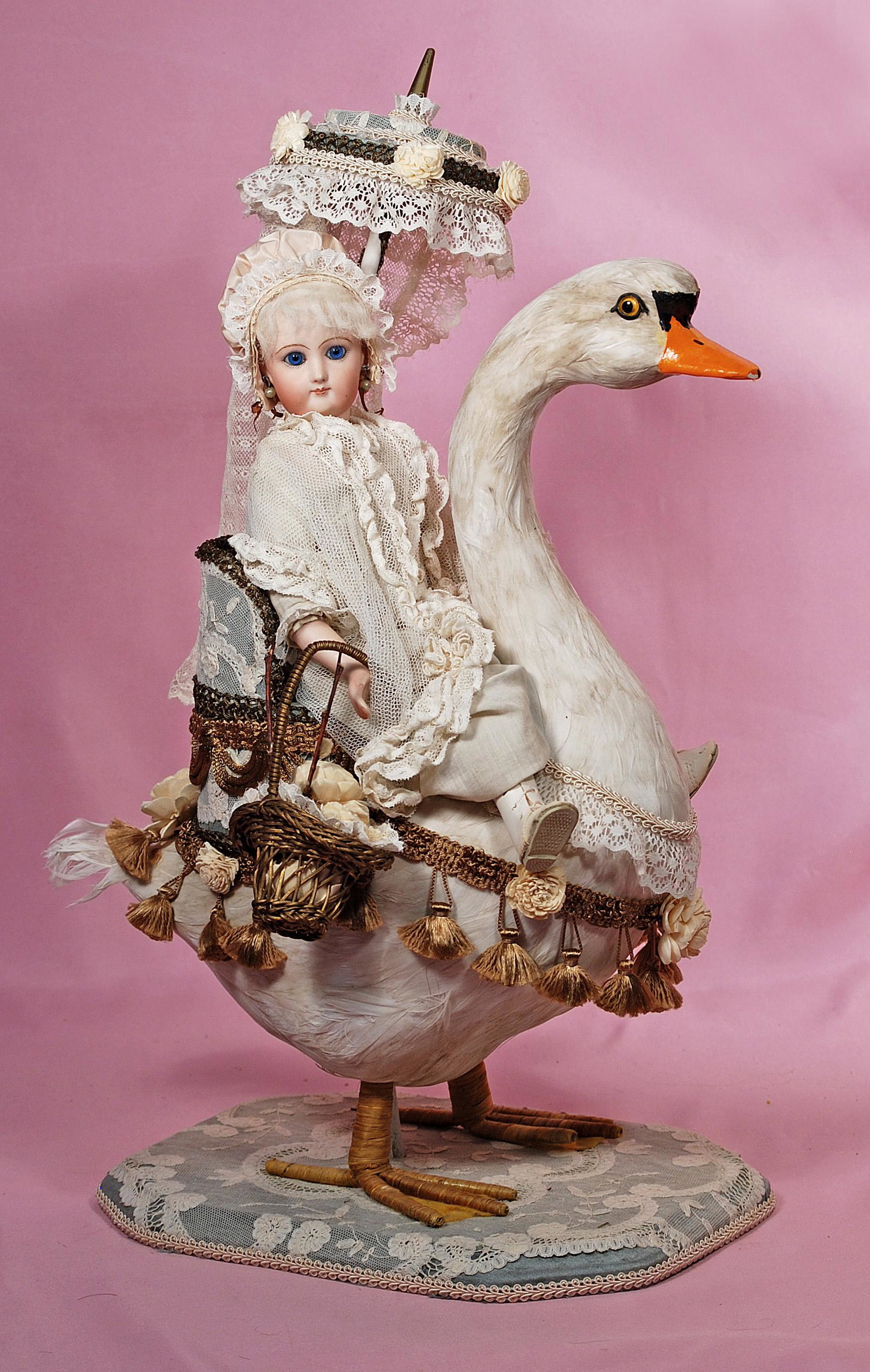CONTEMPORARY BISQUE DOLL RIDING PAPER MACHE GOOSE. (1 of 1)