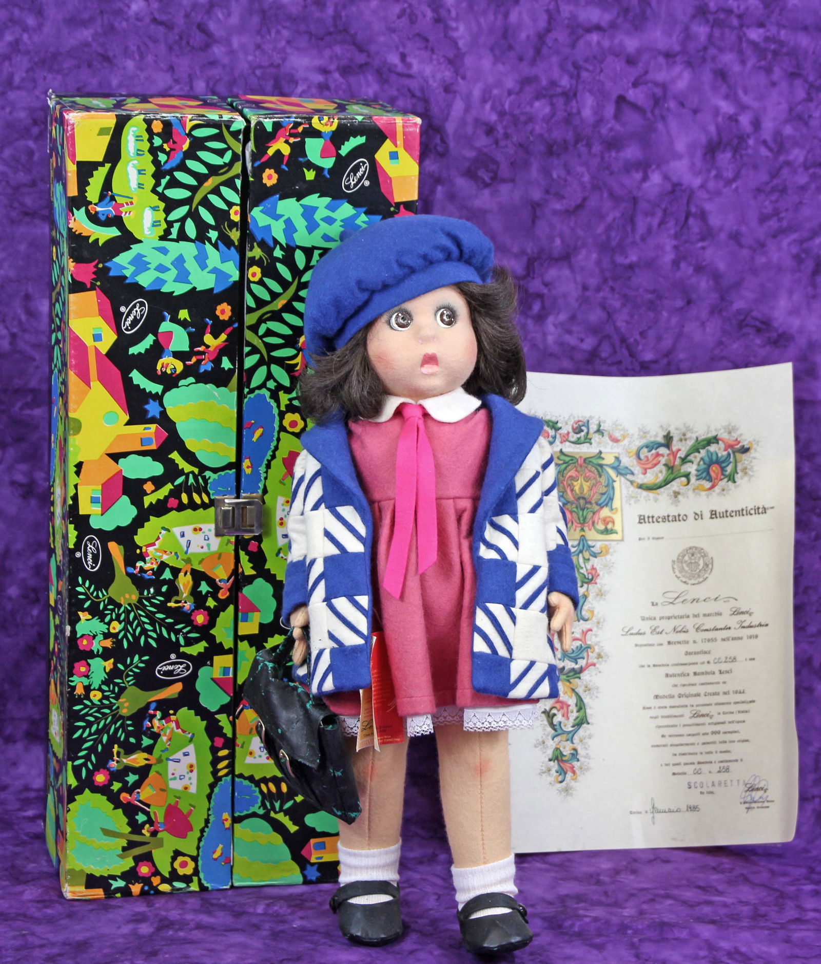 LENCI DOLL "SCOLARETTA": LENCI DOLL "SCOLARETTA". 20" felt doll in original box with tag and COA. Commentary: Very good condition; shoes and purse have vinyl shedding.
