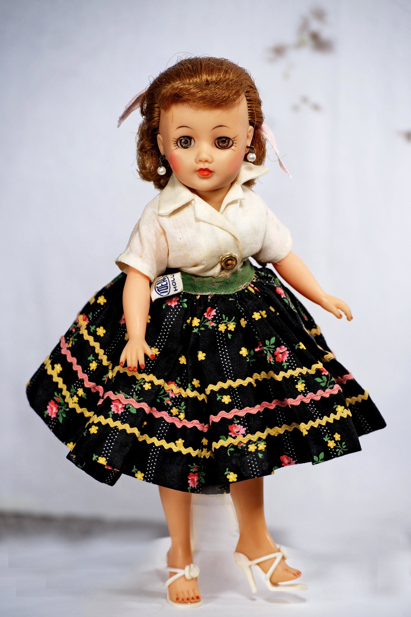 IDEAL LITTLE MISS REVLON IN CALYPSO COSTUME.: IDEAL LITTLE MISS REVLON IN CALYPSO COSTUME. 10 1/2". Vinyl teen doll with swivel waist, rooted light brown hair, sleep eyes, wearing tagged Calypso costume comprised of white cotton shirt and gaily c