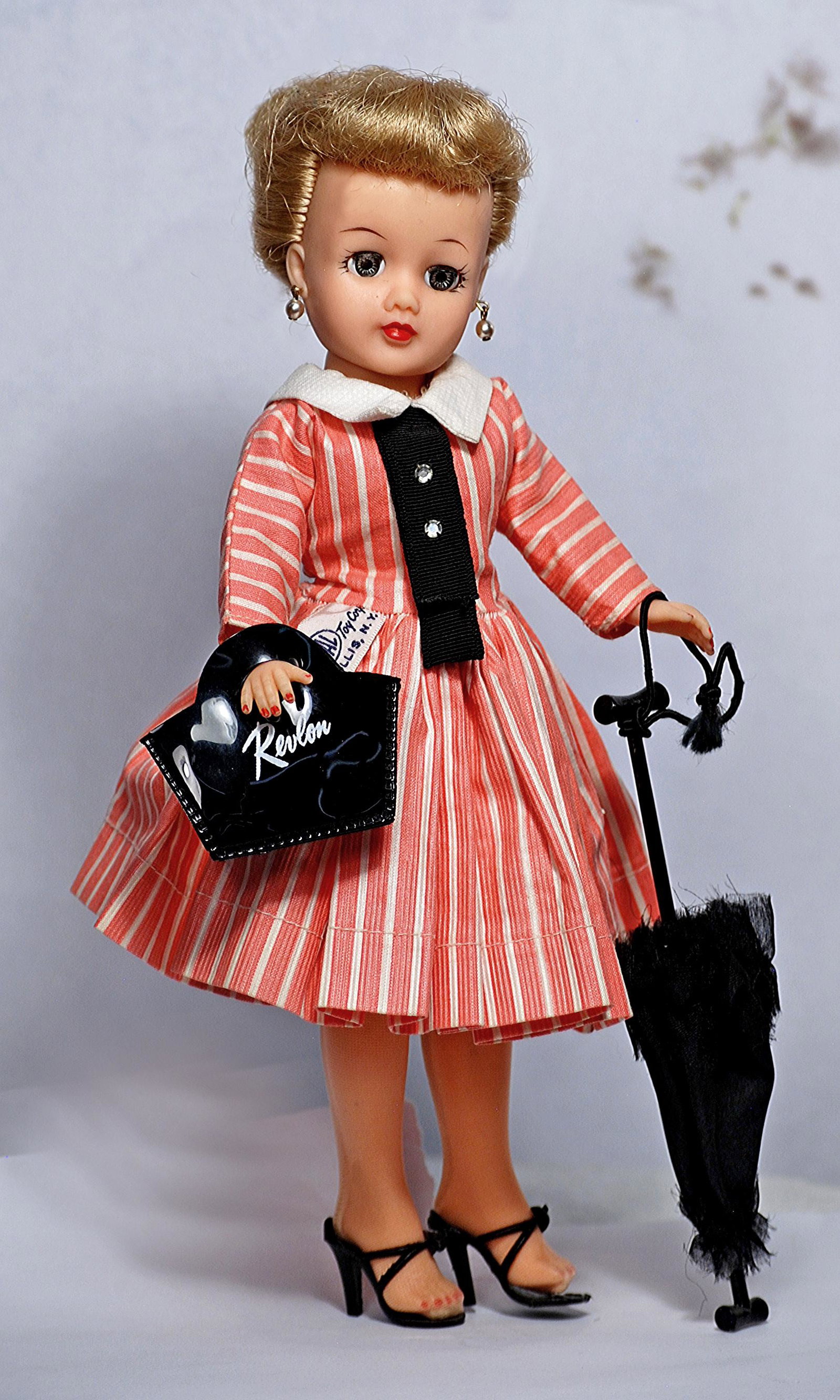 IDEAL LITTLE MISS REVLON IN PINK STRIPED DRESS.: IDEAL LITTLE MISS REVLON IN PINK STRIPED DRESS. 10 1/2". Vinyl teen doll with swivel waist, rooted blonde hair, sleep eyes, wearing pink and white striped cotton dress with black tie, girdle, hose, bl
