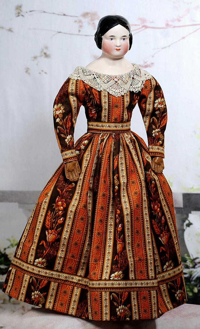 GERMAN PORCELAIN LADY WITH PINK-TINTED COMPLEXION: GERMAN PORCELAIN LADY WITH PINK-TINTED COMPLEXION. 19”. Porcelain shoulder head with pink-tinted complexion, black sculpted smooth, center-parted hair with sausage curls, painted blue eyes, red and 