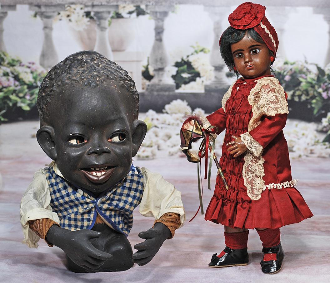 BROWN COMPLEXIONED BEBE, “E: BROWN COMPLEXIONED BEBE, E.D., BY DENAMUR. 15". Marks: E. 5 D. Brown bisque socket head, brown paperweight eyes, painted lashes, black feathered and brushstroked brows, pierced ears, open mouth, upper