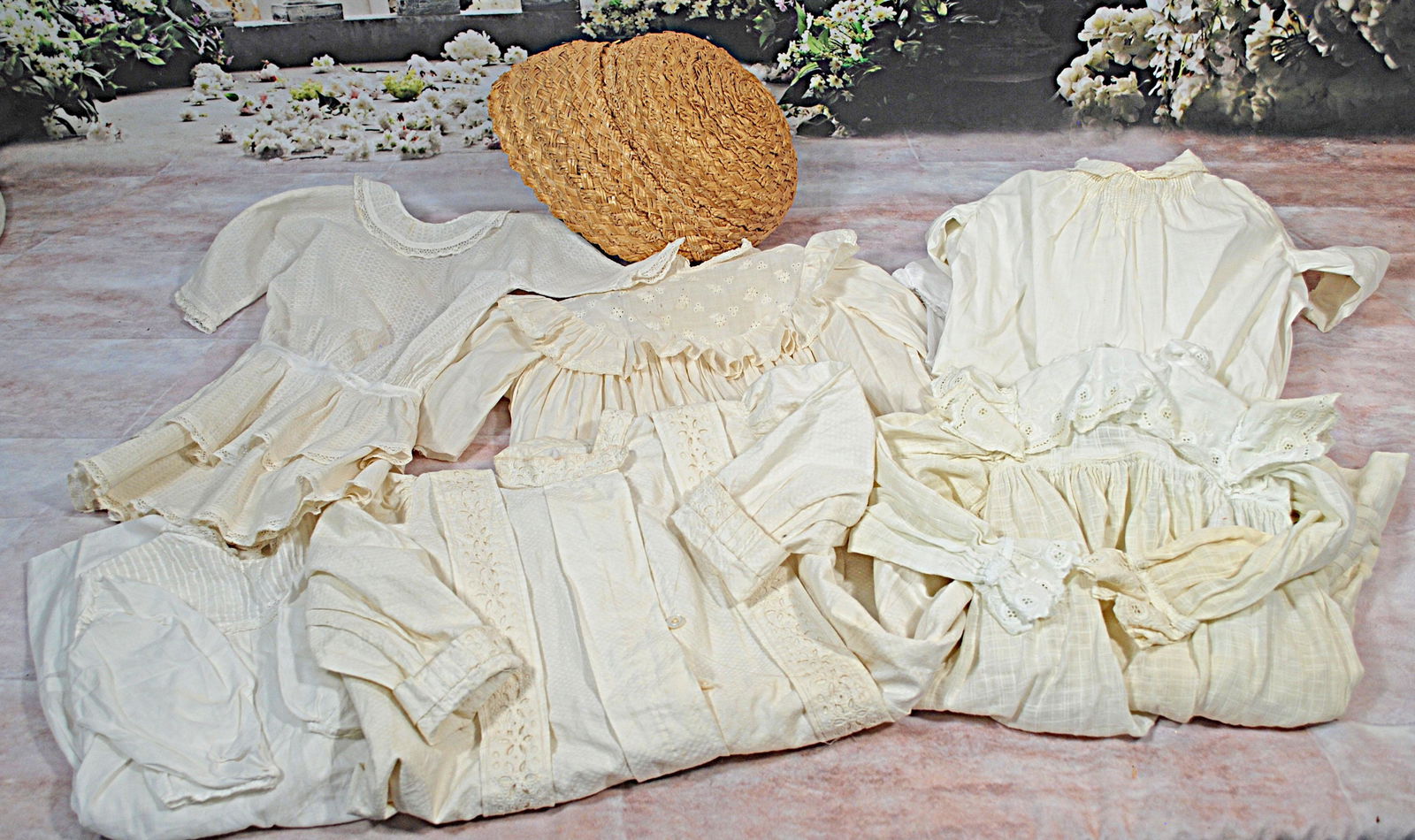 LOT OF ANTIQUE WHITE DOLL DRESSES & LARGE STRAW DOLL (1 of 1)