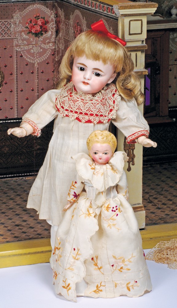 TINY WAX-OVER-PAPIER MACHE DOLL WITH GLASS EYES. 8: TINY WAX-OVER-PAPIER MACHE DOLL WITH GLASS EYES. 8 ½". Wax-over papier mache shoulderhead, molded and painted blonde hair with painted black headband, inset brown glass eyes, original slender muslin 