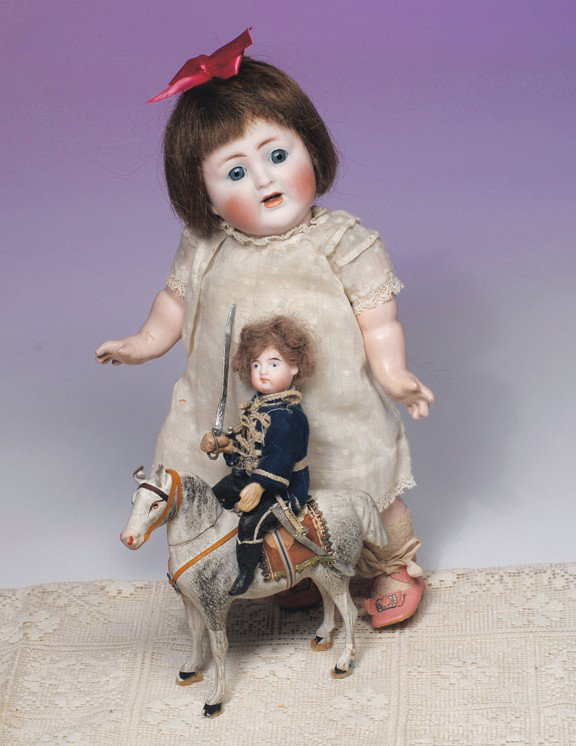 GERMAN BISQUE SOLDIER ON PAPIER MACHE HORSE. 6 ¾" : GERMAN BISQUE SOLDIER ON PAPIER MACHE HORSE. 6 ¾" H. Bisque head doll with painted features and composition body wears original felt jacket, lower body has painted black tights and tall black boots, 