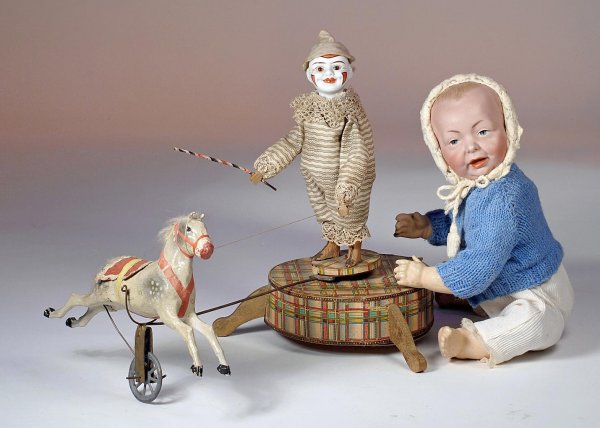 KEY-WIND, BISQUE-HEADED CIRCUS CLOWN WITH HORSE. : KEY-WIND, BISQUE-HEADED CIRCUS CLOWN WITH HORSE. 12 ½" H. Marks: 157 (back of head). Bisque-head clown has untinted bisque head with painted clown features, inset brown glass eyes, smiling open/close