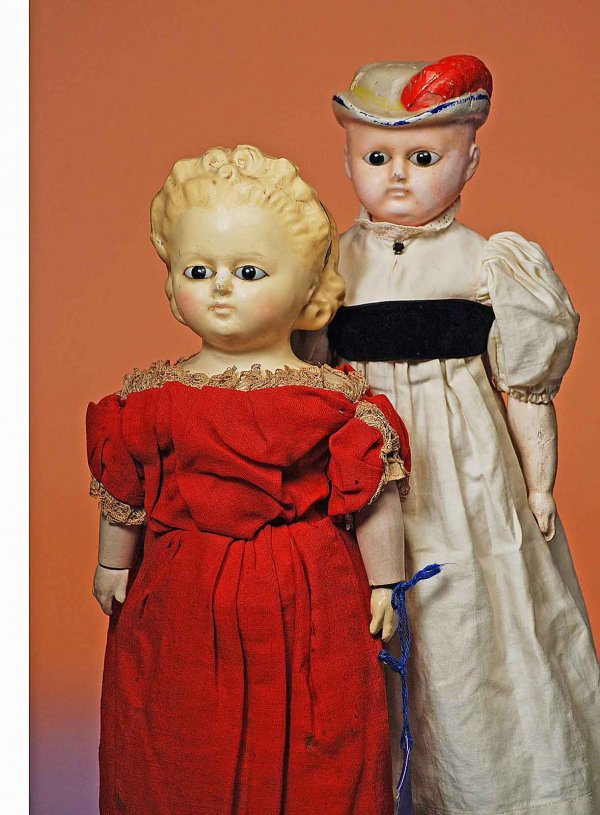 GERMAN "BONNET HEAD" WAX-OVER-PAPIER MACHE DOLL. : GERMAN "BONNET HEAD" WAX-OVER-PAPIER MACHE DOLL. 18". Shoulderhead model has molded and painted light blue bonnet with red plume, almond-shaped inset dark glass eyes, closed mouth, original muslin bod