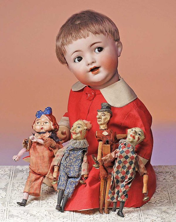 FOUR ANTIQUE GERMAN SQUEAK TOYS. 6" to 7". Each : FOUR ANTIQUE GERMAN SQUEAK TOYS. 6" to 7". Each has molded papier mache character head with painted features, wooden limbs, wooden squeak bellow torso, cotton clothing. Commentary: All-original toys w