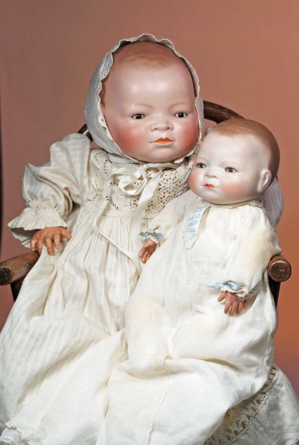 GERMAN BISQUE LIFE-SIZE, BROWN-EYED BYE-LO BABY. : GERMAN BISQUE LIFE-SIZE, BROWN-EYED BYE-LO BABY. Marks: Copr. Grace S. Putnam. 21"; head circ. 18". Solid-dome bisque swivel head, molded and painted light brown hair, brown sleep eyes, painted lashes