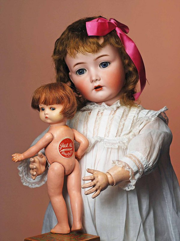 GERMAN BISQUE "JUST ME" BY MARSEILLE. Marks: Jus: GERMAN BISQUE "JUST ME" BY MARSEILLE. Marks: Just ME registered trademark/ Germany A 810 M (incised); original label on back. 10". Painted bisque socket head, blue side-glancing sleep eyes, amber eye
