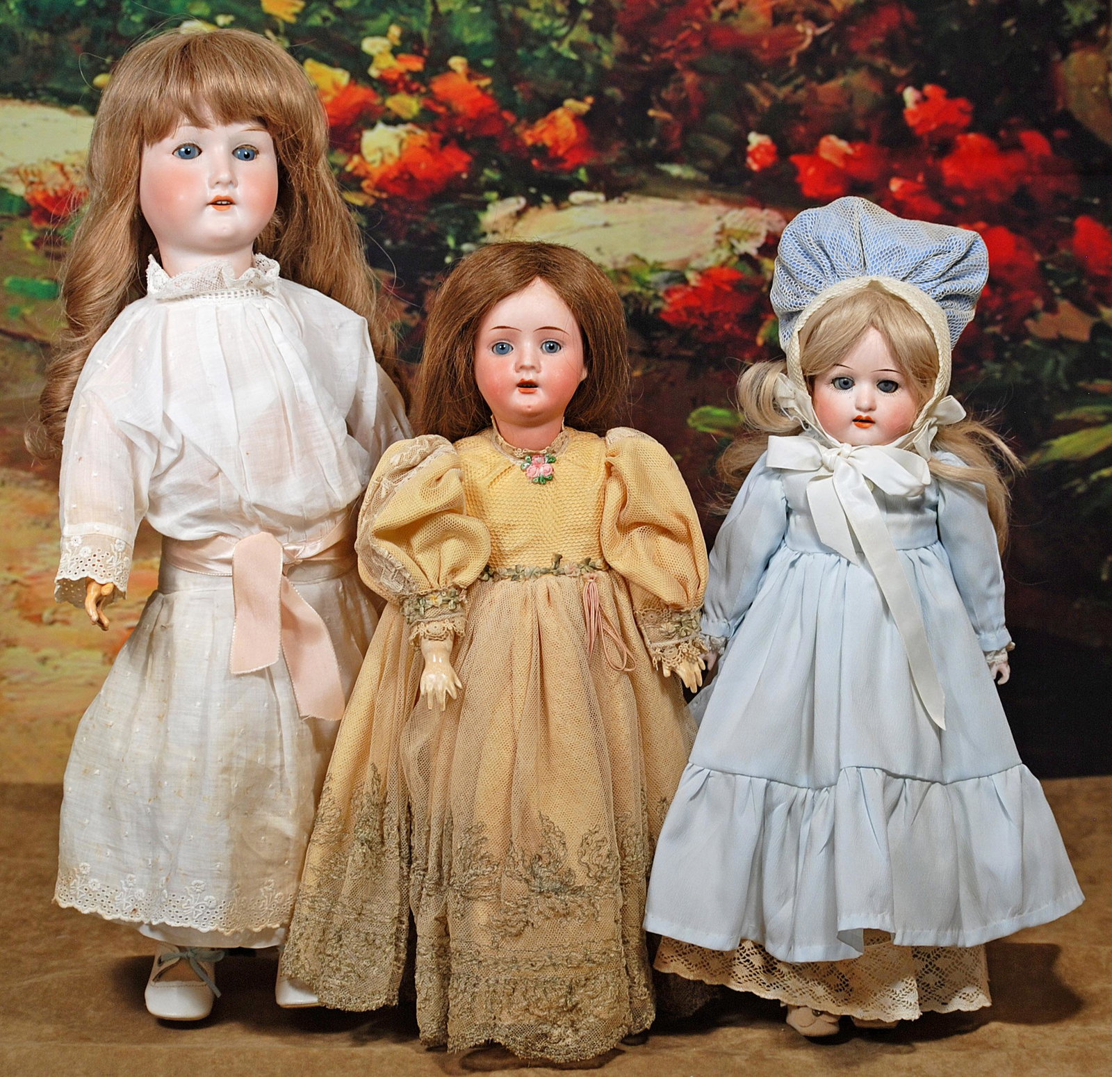 THREE GERMAN BISQUE DOLLS: THREE GERMAN BISQUE DOLLS. 14", 15" and 19". Each has sleep eyes, open mouth, upper teeth, human hair wig, 14" doll is shoulderhead on kid body with bisque lower arms; 15" and 19" dolls are socket hea