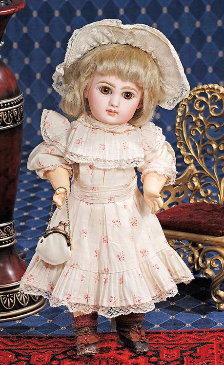 FRENCH BISQUE JUMEAU BEBE IN FACTORY DRESS AND SHO: FRENCH BISQUE JUMEAU BEBE IN FACTORY DRESS AND SHOES. Marks: Tete Jumeau Bte SGDG 4. 13 ½". Bisque socket head, light brown paperweight eyes, dark eyeliner, painted lashes, feathered and brushstroked