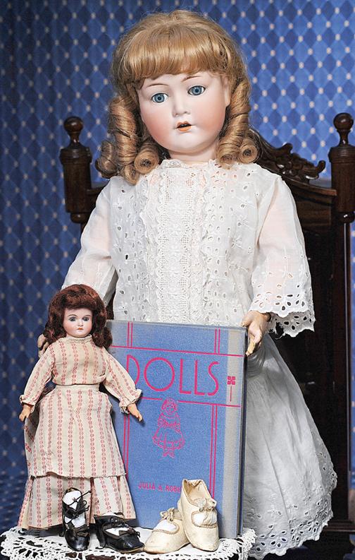 PETITE GERMAN BISQUE DOLL BY KLING. Marks: 164/: PETITE GERMAN BISQUE DOLL BY KLING. Marks: 164/K in bell. 11 ½". Solid-dome bisque shoulderhead, stationary blue glass eyes, painted lashes, feathered brows, closed mouth, accented lips, auburn synth