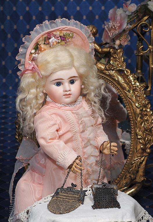 TWO ANTIQUE BEADED DOLL PURSES. 4" beaded tapere: TWO ANTIQUE BEADED DOLL PURSES. 4" beaded tapered purse with ornately embossed metal frame and metal chain; 2 ¼" rectangular shaped purse with metal frame and chain. Commentary: Very good condition.