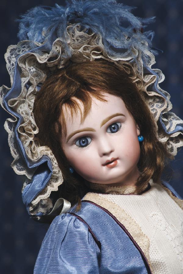 FRENCH BISQUE BEBE BY JUMEAU. Marks: Depose Tet: FRENCH BISQUE BEBE BY JUMEAU. Marks: Depose Tete Jumeau Bte SGDG 8. 20". Bisque socket head, blue paper-weight eyes, painted lashes, feathered and brushstroked brows, pierced ears, closed mouth, shade