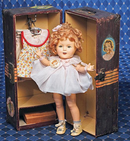IDEAL COMPOSITION SHIRLEY TEMPLE WITH TRUNK. Mar: IDEAL COMPOSITION SHIRLEY TEMPLE WITH TRUNK. Marks: Shirley Temple Ideal N & T (on head); Shirley Temple (body). 13". Composition socket head on five-piece jointed body, sleep eyes, applied and painte