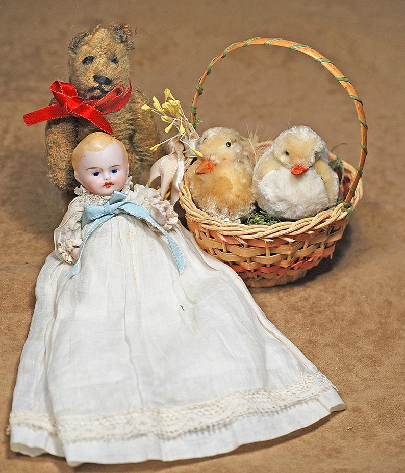 106.  MINIATURE GERMAN ALL-BISQUE BABY WITH BASKET OF (1 of 1)