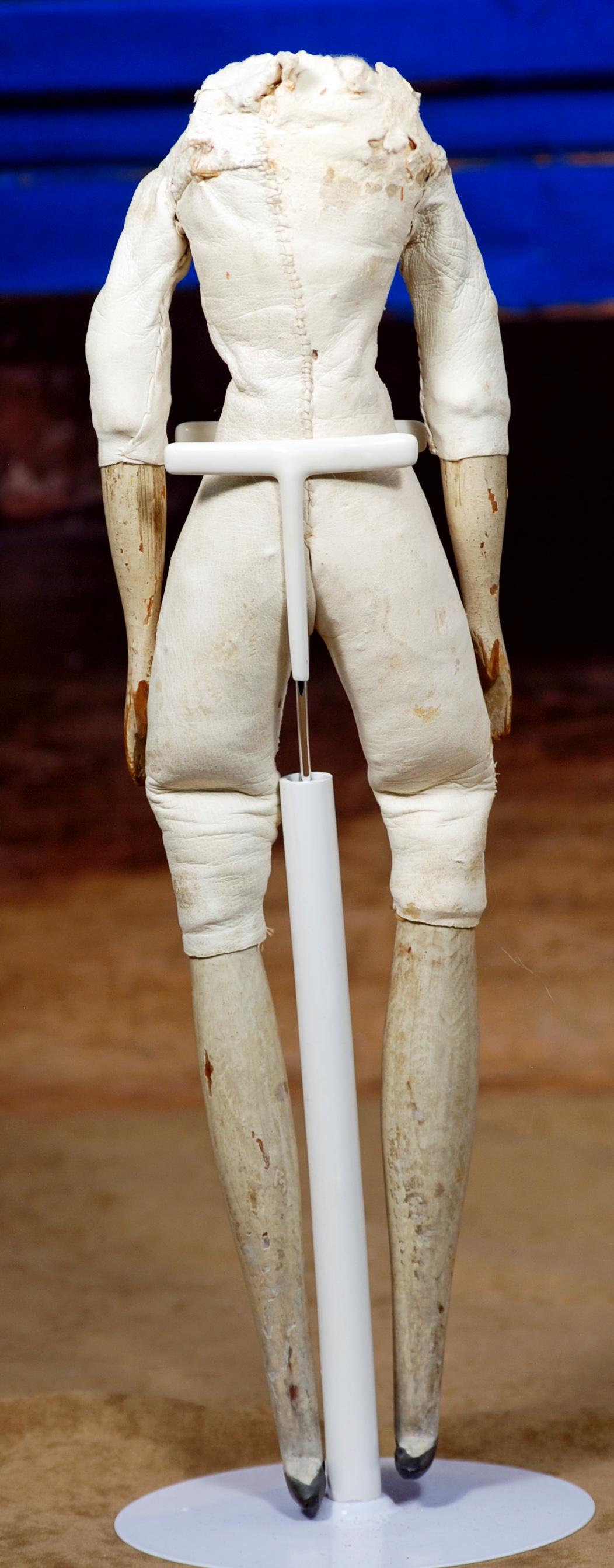 243. ANTIQUE BODY FOR MILLINER MODEL. Kid leather: 243. ANTIQUE BODY FOR MILLINER MODEL. Kid leather slender body with lower wooden arms and leg, worn at top/shoulders. Height 13".