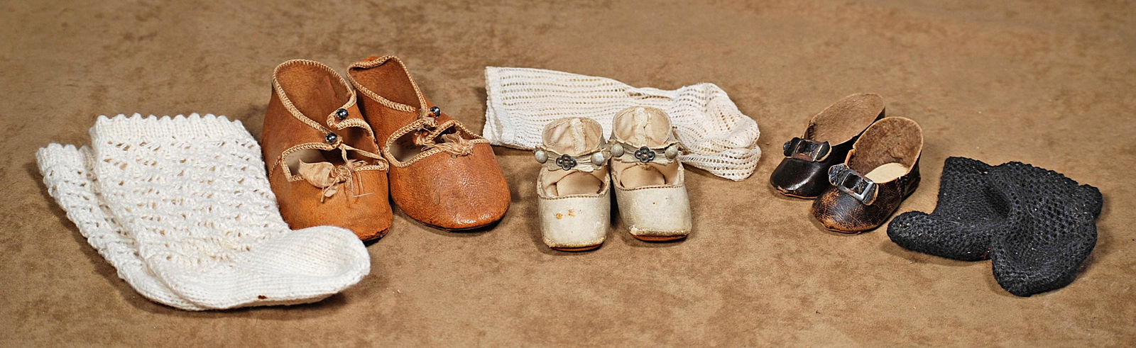 248.  THREE PAIR OF ANTIQUE DOLL SHOES AND SOCKS. (1 of 1)
