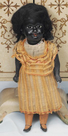 TINY BLACK BISQUE DOLL BY GEBRUDER KNOCH. Marks: c: TINY BLACK BISQUE DOLL BY GEBRUDER KNOCH. Marks: cross symbol/ Made in Germany 193 Dep. 8 ½". Black bisque socket head, inset dark glass eyes, open mouth, upper teeth, black mohair wig, five-piece jo