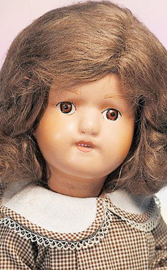 SCHOENHUT CARVED WOODEN DOLL. Marks: Schoenhut D: SCHOENHUT CARVED WOODEN DOLL. Marks: Schoenhut Doll Pat. Jan. 17th, 1911 USA (sticker on body). 15". Carved wooden socket head, painted features, brown eyes, painted lashes, brushstroked brows, open/c