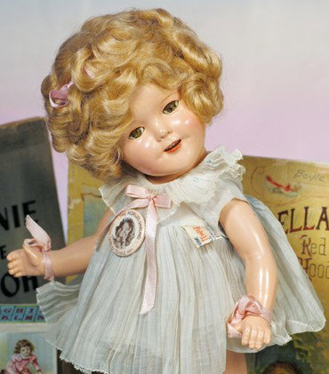 IDEAL SHIRLEY TEMPLE COMPOSITION DOLL IN "BABY TAK: IDEAL SHIRLEY TEMPLE COMPOSITION DOLL IN "BABY TAKE A BOW" OUTFIT. Marks: 50 Shirley Temple (on head); Shirley Temple 16 (on body). 16". Composition socket head on five-piece jointed body, sleep eyes,