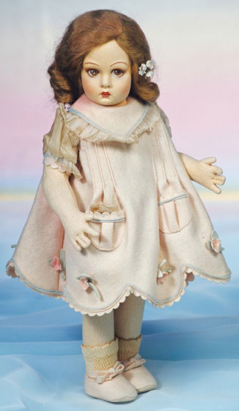 1930'S LENCI FELT DOLL WITH "LUCIA" FACE. Marks: 1930'S LENCI FELT DOLL WITH "LUCIA" FACE. Marks: red and white Lenci tag on dress. 14". Felt swivel head with mask pressed and painted facial features, brown side-glancing eyes, painted upper lashes,