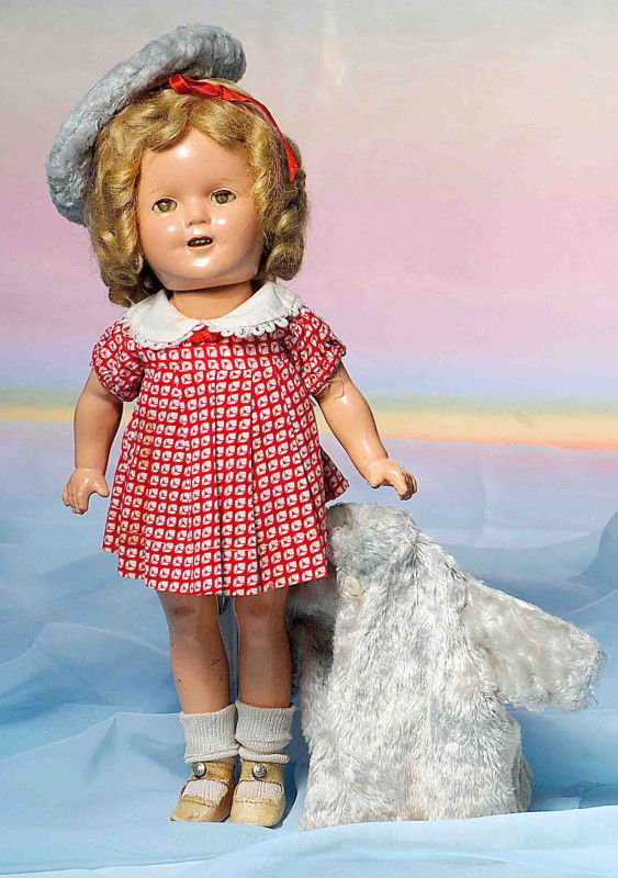 COMPOSITION SHIRLEY TEMPLE BY IDEAL.: Marks: Shirley Temple 13. 13”. Composition socket head on five-piece jointed body, original blonde wig, sleep eyes, applied upper lashes, painted lower lashes, open mouth, upper teeth, wears NRA tag