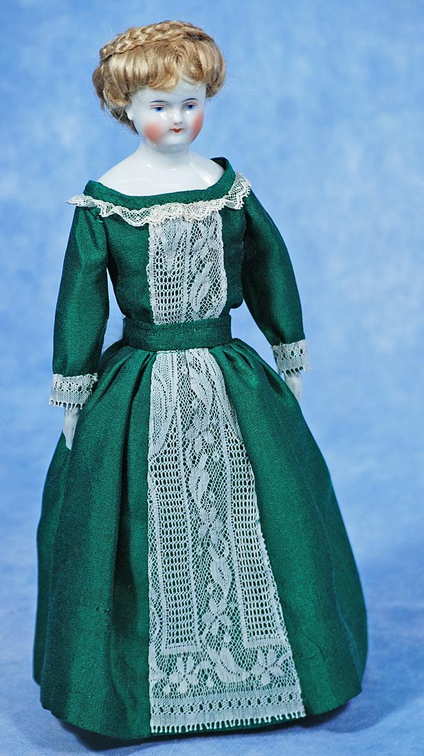 GERMAN PORCELAIN LADY KNOWN AS BIEDERMEIER: 8. GERMAN PORCELAIN LADY KNOWN AS BIEDERMEIER. 13”. Porcelain shoulderhead, solid-domed with painted black pate under blonde mohair wig, painted features, blue eyes, red and black upper eyeliner
