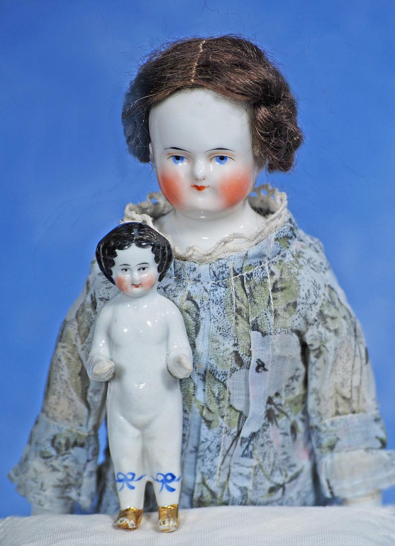 GERMAN PORCELAIN BIEDERMEIER LADY & ALL-PORCELAIN DOLL WITH GILT BOOTS: 25. GERMAN PORCELAIN BIEDERMEIER LADY & ALL-PORCELAIN DOLL WITH GILT BOOTS. 12” porcelain lady with solid-dome shoulderhead and painted black pate, brown mohair wig, painted features, shaded blu