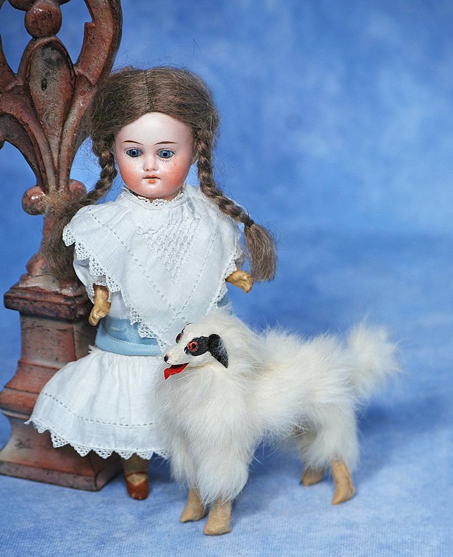 TINY GERMAN BISQUE DOLL BY HERM STEINER: 46. TINY GERMAN BISQUE DOLL BY HERM STEINER. 7”. Marks: Made in Germany, Herm Steiner 18/0. Bisque socket head, stationary blue glass eyes, painted lashes, tapered brows, open mouth, upper teeth