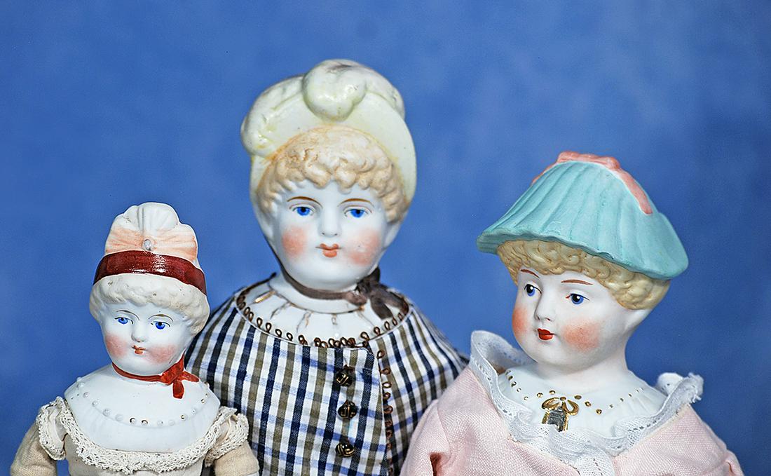 THREE GERMAN BISQUE DOLLS WITH SCULPTED BONNETS AND BODICE (1 of 2)