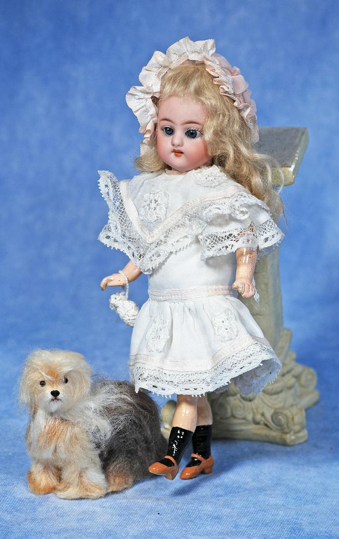 PETITE SIMON & HALBIG BISQUE WALKER DOLL WITH MINIATURE MOHAIR PUP: 74. PETITE SIMON & HALBIG BISQUE WALKER DOLL WITH MINIATURE MOHAIR PUP. 8”. Marks: S 5 H. Bisque socket head, blue sleep eyes, painted lashes, feathered brows, open mouth, upper teeth, original