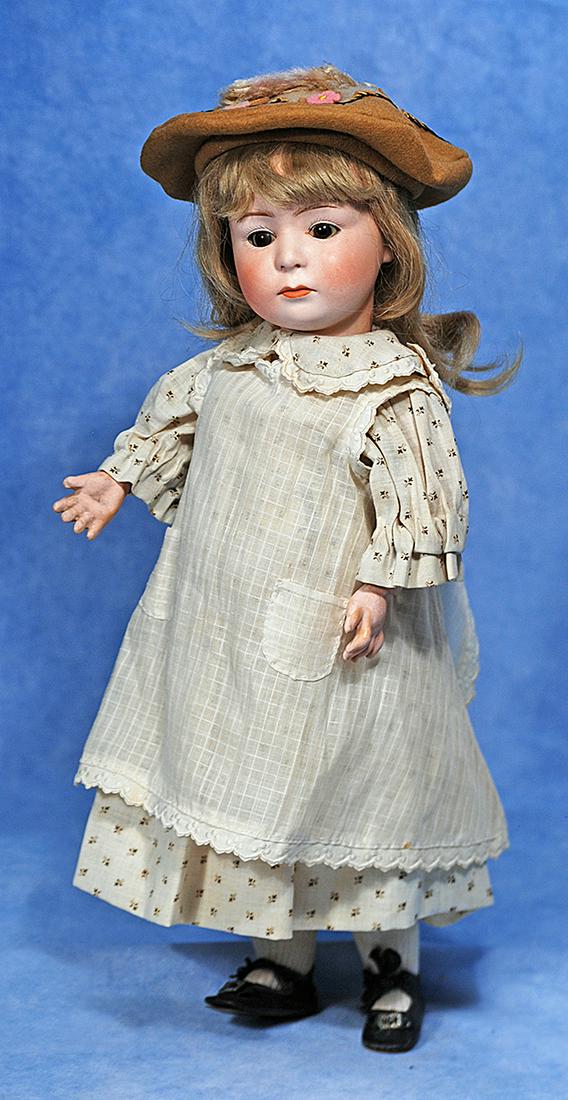 GERMAN BISQUE GLASS-EYED POUTY, 7246, BY GEBRUDER HEUBACH: 142. GERMAN BISQUE GLASS-EYED POUTY, 7246, BY GEBRUDER HEUBACH. 15”. Marks: 7246/ 5 Germany and Heubach sunburst mark. Bisque socket head, brown glass sleep eyes, painted lashes, feathered brows