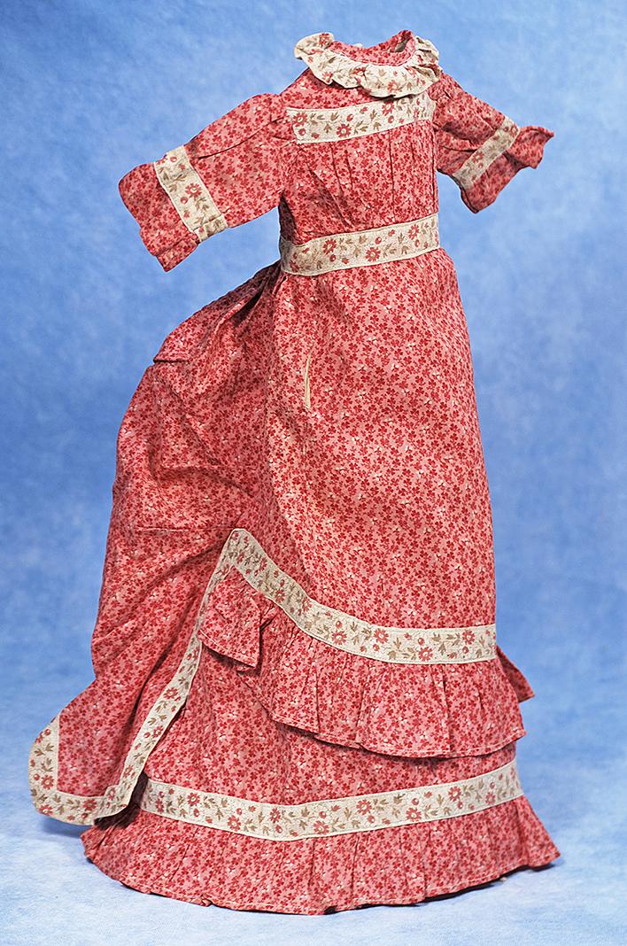 EARLY COTTON PRINT DAY DRESS FOR LADY DOLL: 174. EARLY COTTON PRINT DAY DRESS FOR LADY DOLL. Finely woven cotton with tiny transfer printed red/pink floral design, features slightly high waist with set-in waistband, gathered bodice, inset sleev