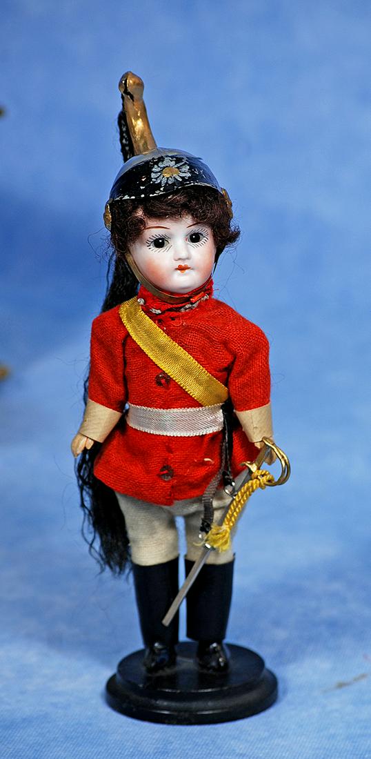 MINIATURE ITALIAN BISQUE DOLL IN ORIGINAL UNIFORM: 178. MINIATURE ITALIAN BISQUE DOLL IN ORIGINAL UNIFORM. 6 ½”. Marks: Italy. Bisque socket head, stationary brown glass eyes, painted lashes, tapered brows, closed mouth, original mohair w
