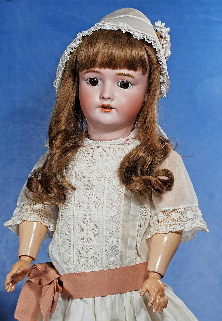 GERMAN BISQUE CHILD BY HANDWERCK: 185. GERMAN BISQUE CHILD BY HANDWERCK. 29”. Marks: 109 - 15 DEP Germany, Handwerck. Bisque socket head, brown sleep eyes, painted lashes, feathered brows, pierced ears, open mouth, accented lips