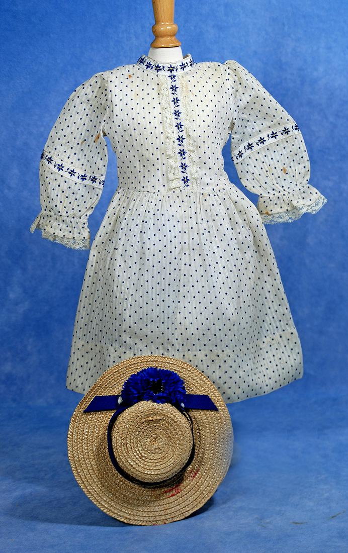 DOLL DRESS AND BONNET: 200. DOLL DRESS AND BONNET. White and blue dotted swiss/voile dress with fitted bodice, long sleeves, gathered skirt, trimmed at neckline, bodice and sleeves with bands of navy blue floral trim, back 